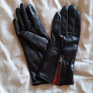 Black leather gloves with zipper detail, size 7